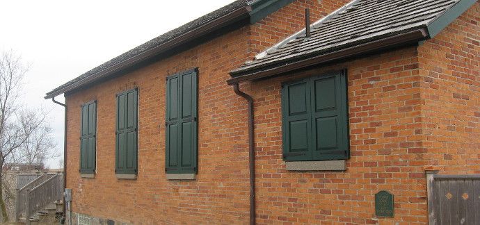 Closed panel shutters on a refurbished school house